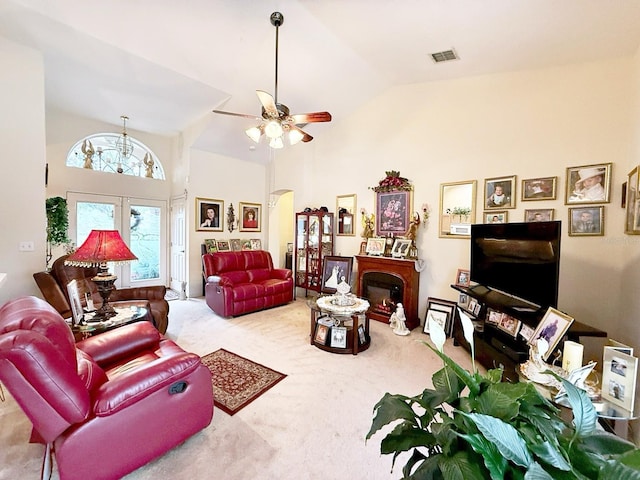 carpeted living room with french doors, ceiling fan, and high vaulted ceiling