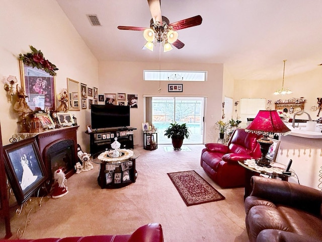 carpeted living room with ceiling fan with notable chandelier and a towering ceiling