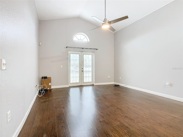 empty room featuring vaulted ceiling, dark hardwood / wood-style floors, ceiling fan, and french doors