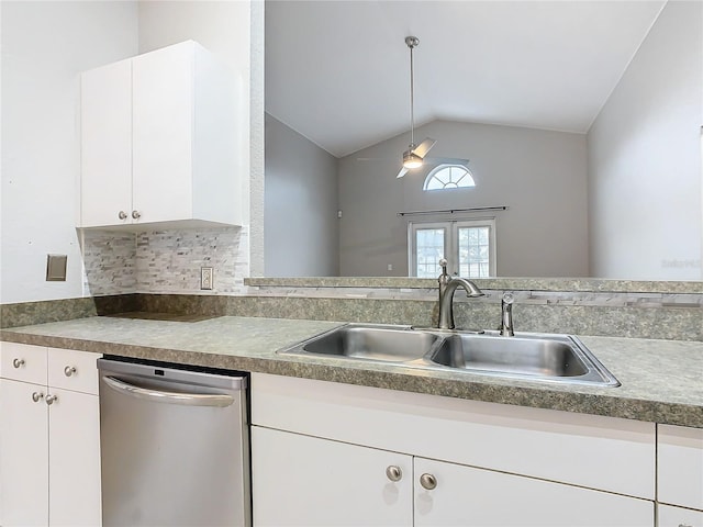 kitchen with dishwasher, vaulted ceiling, and white cabinets