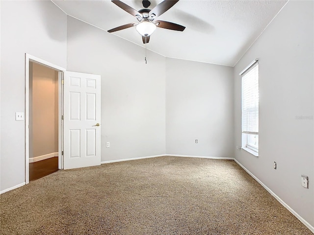 carpeted spare room featuring ceiling fan