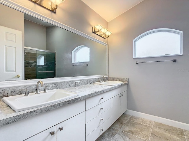 bathroom with vaulted ceiling, vanity, and a shower with door