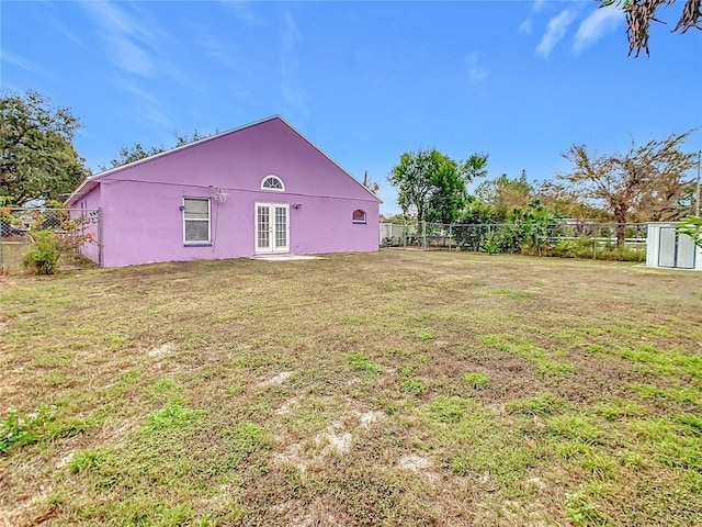 rear view of property with a yard and french doors