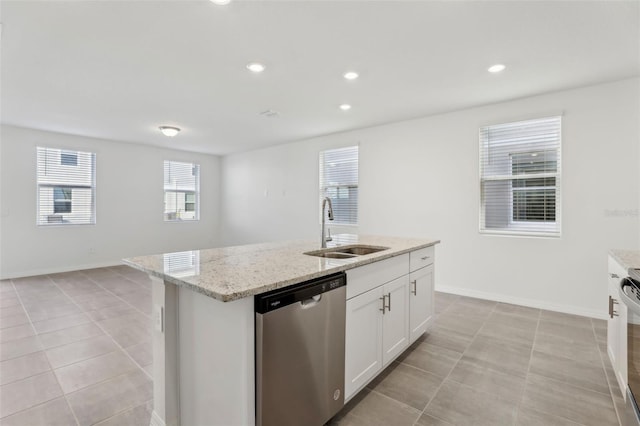 kitchen with sink, white cabinetry, a center island with sink, appliances with stainless steel finishes, and light stone countertops