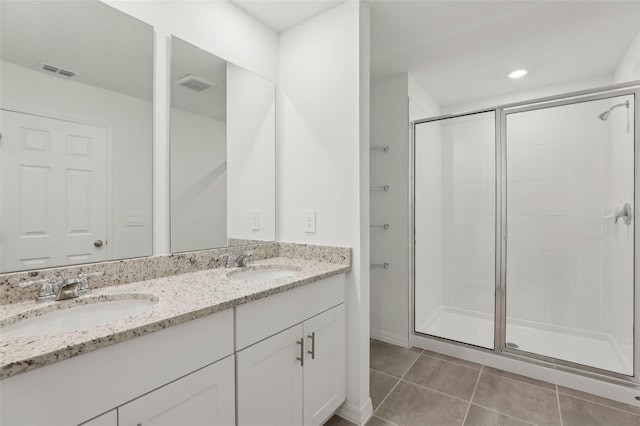 bathroom with walk in shower, tile patterned floors, and vanity