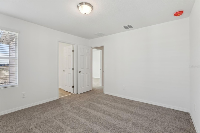 unfurnished room with light colored carpet