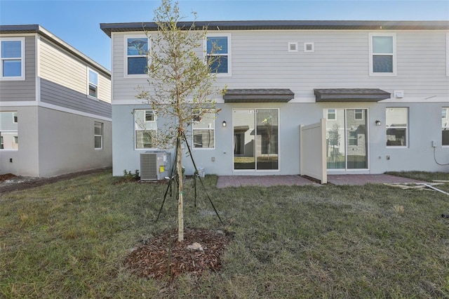 back of house featuring a yard and cooling unit