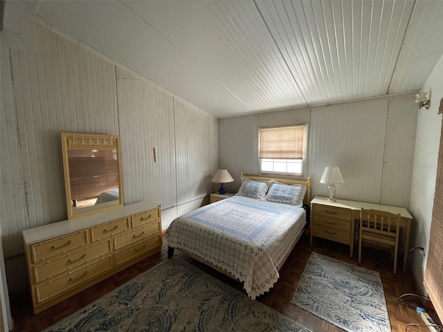 bedroom featuring wooden walls and dark hardwood / wood-style flooring