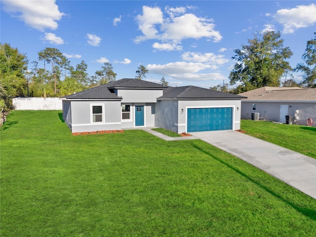 view of front of property with a garage, a front lawn, and central air condition unit