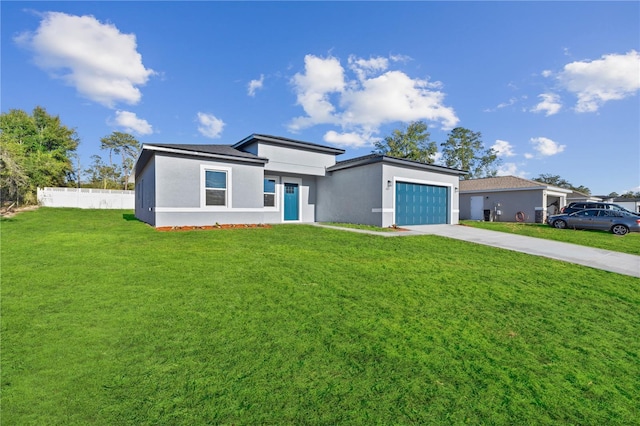 view of front of home featuring a garage and a front yard