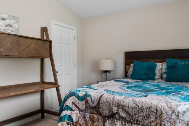 bedroom with lofted ceiling and carpet floors