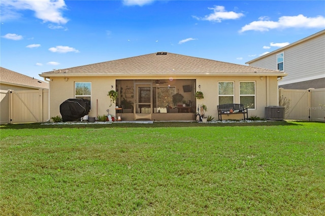 back of property featuring cooling unit and a yard