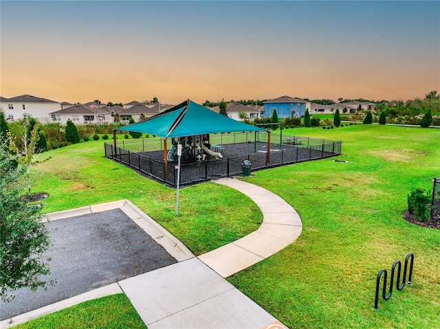 view of property's community featuring a playground and a lawn