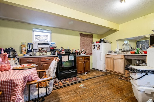 kitchen with beamed ceiling, white refrigerator, dark wood-type flooring, black electric range, and a textured ceiling