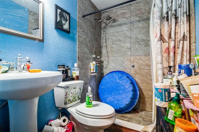 bathroom with toilet and a shower with shower curtain