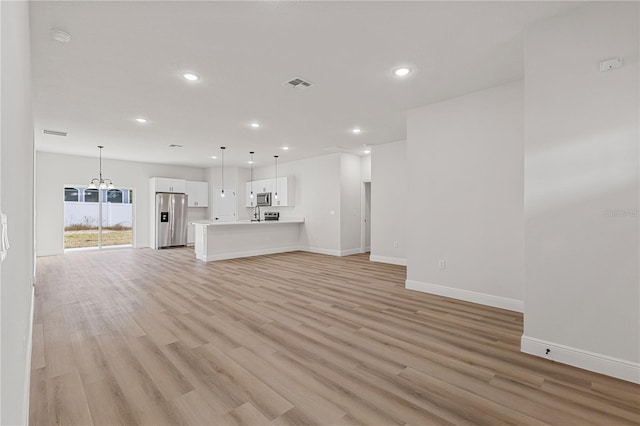 unfurnished living room with light wood-type flooring