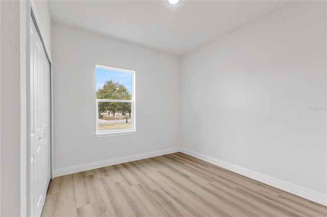 unfurnished bedroom featuring a closet and light wood-type flooring