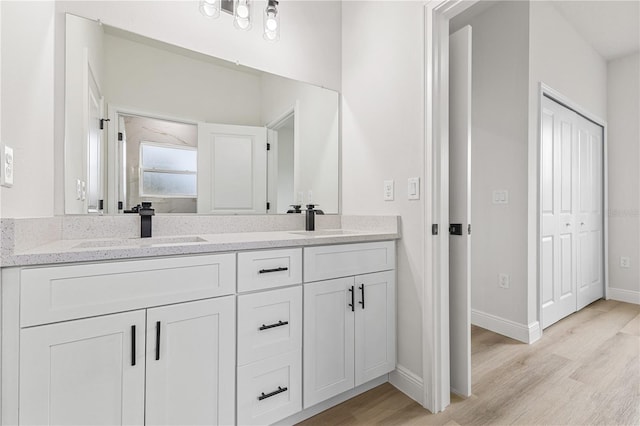 bathroom with vanity and hardwood / wood-style floors