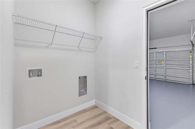 laundry room featuring washer hookup and light wood-type flooring