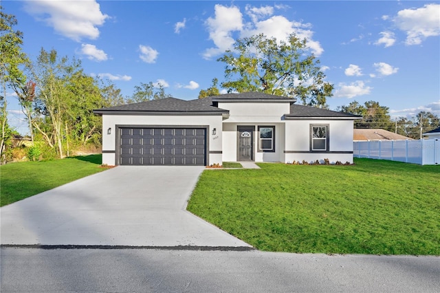 prairie-style home with a garage and a front lawn