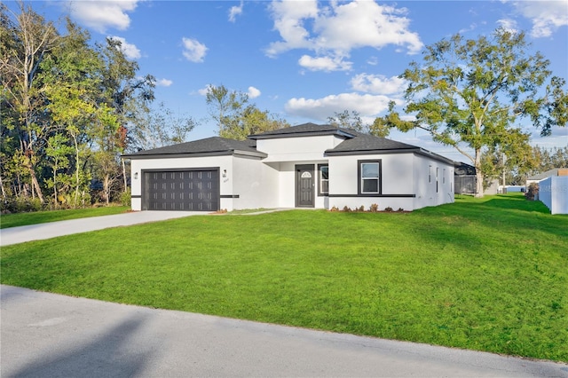 view of front of house featuring a garage and a front lawn