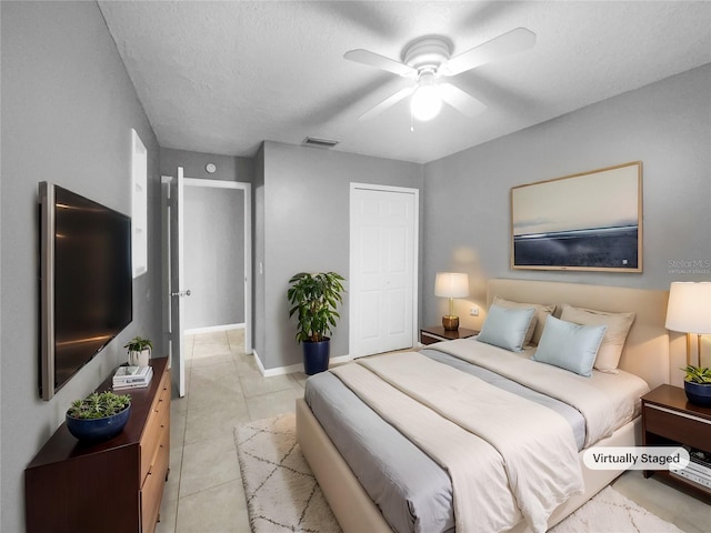 tiled bedroom featuring ceiling fan