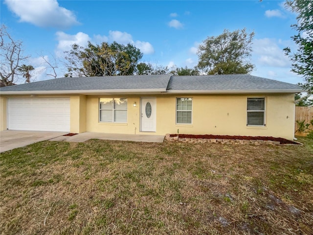 single story home with a garage and a front yard