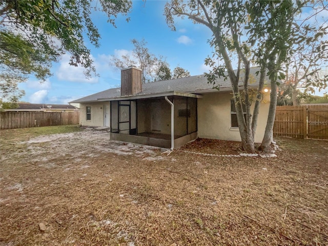 rear view of property with a sunroom