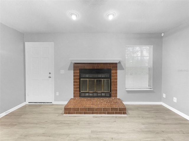 unfurnished living room featuring hardwood / wood-style floors and a fireplace