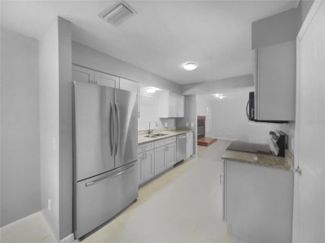 kitchen featuring stainless steel appliances, sink, and white cabinets