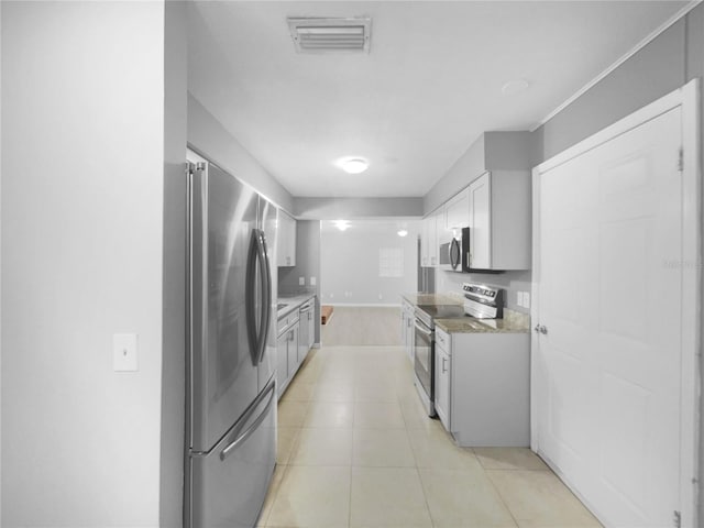 kitchen featuring light stone countertops, white cabinets, and appliances with stainless steel finishes