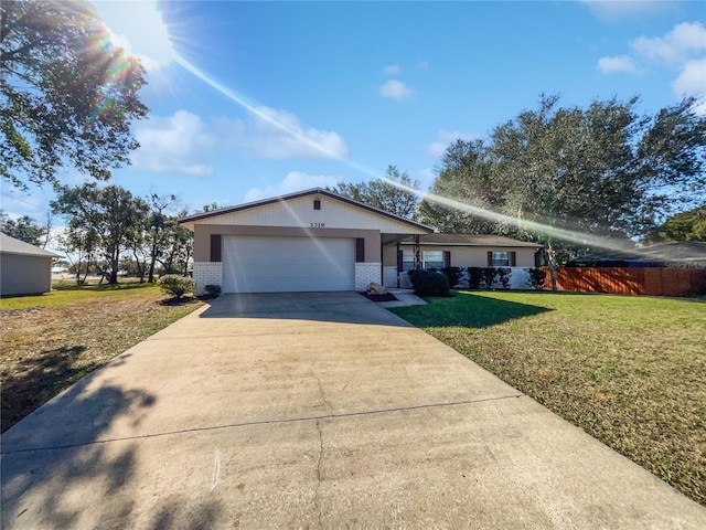 single story home with a garage and a front lawn