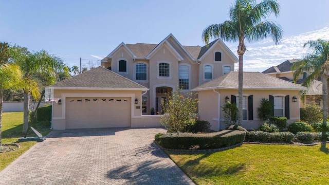 view of front of home with a garage and a front lawn