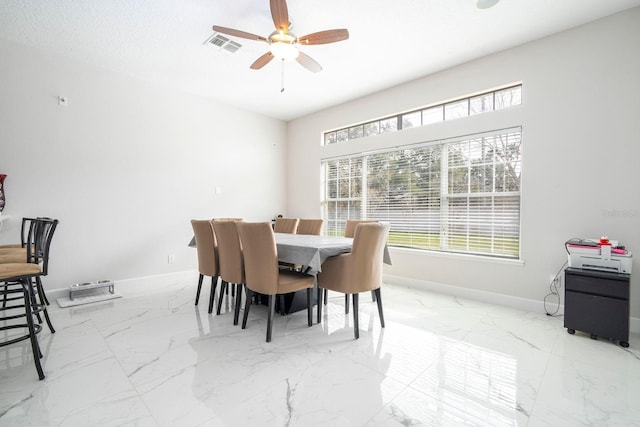 dining space with ceiling fan