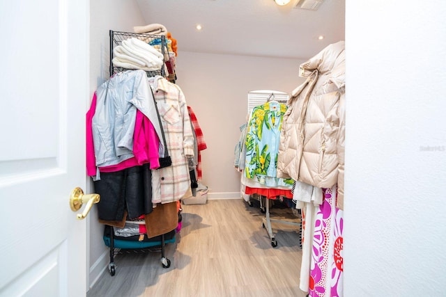 walk in closet featuring light hardwood / wood-style flooring