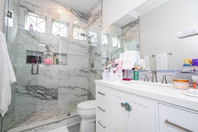 bathroom with vanity, toilet, and a shower with shower door