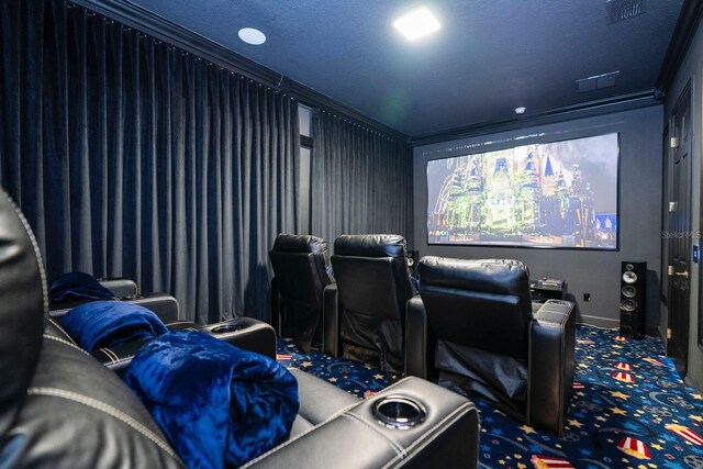 carpeted home theater with crown molding