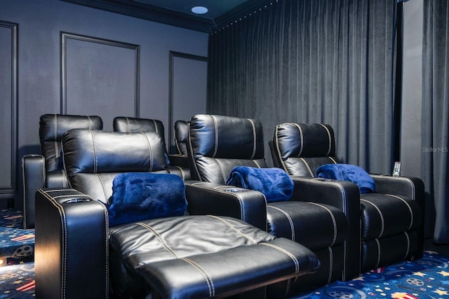 carpeted cinema room featuring ornamental molding