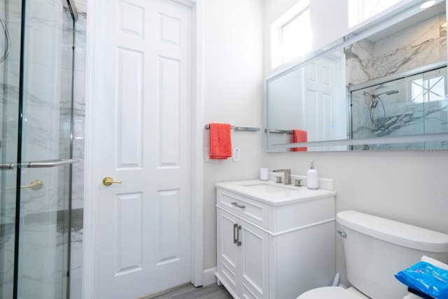 bathroom with vanity, toilet, and an enclosed shower