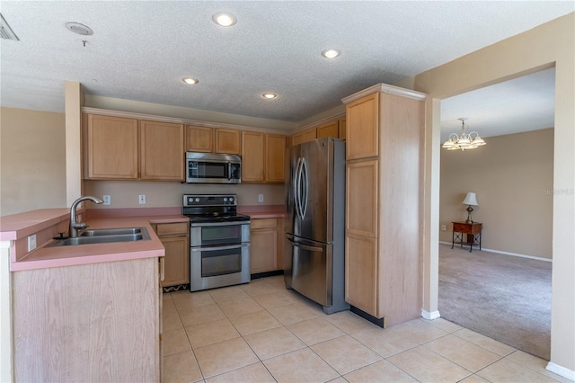 kitchen featuring light tile patterned flooring, pendant lighting, light brown cabinetry, sink, and stainless steel appliances