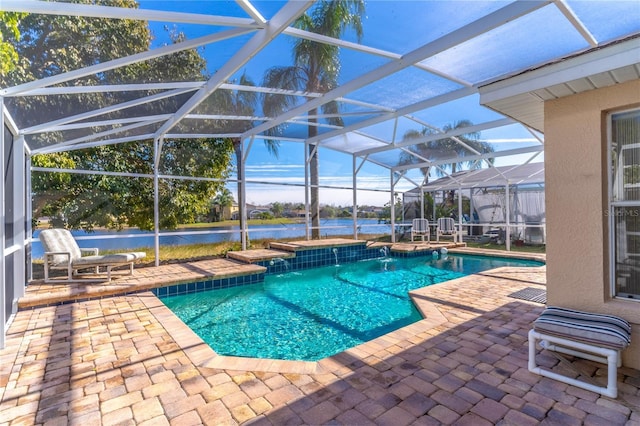 view of swimming pool with a lanai, a patio area, pool water feature, and a water view