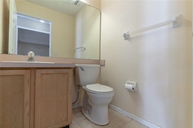 bathroom featuring vanity, tile patterned floors, and toilet