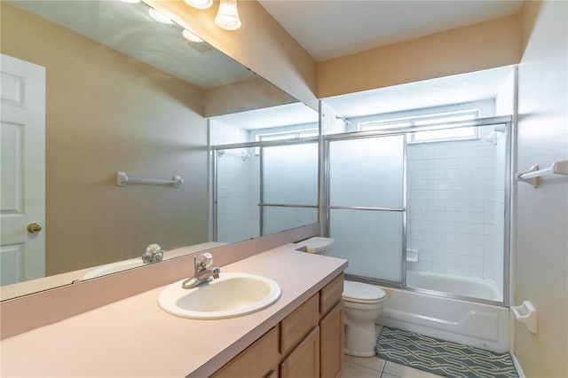 full bathroom featuring toilet, tile patterned floors, shower / bath combination with glass door, and vanity