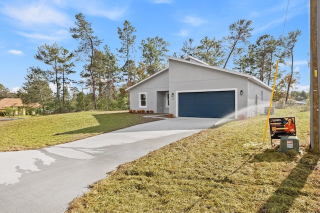 view of front of home with a garage and a front lawn