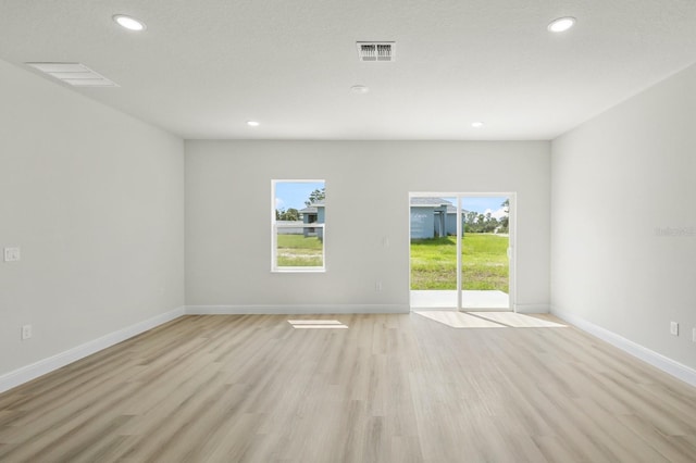 spare room featuring light hardwood / wood-style flooring