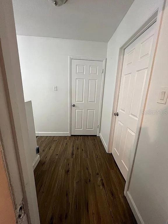 corridor featuring dark hardwood / wood-style flooring