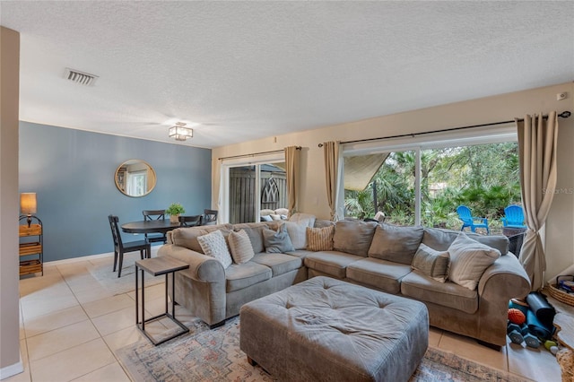 tiled living room featuring a textured ceiling