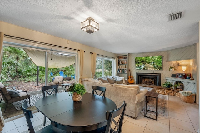 tiled dining area with a textured ceiling and wood walls