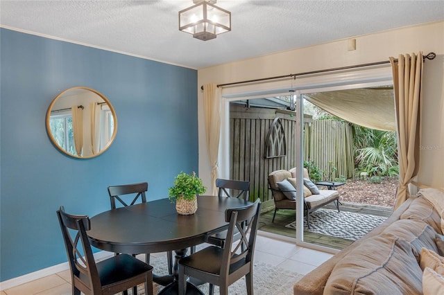 dining space featuring light tile patterned floors and a textured ceiling