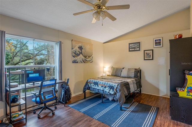 bedroom with dark hardwood / wood-style flooring, vaulted ceiling, a textured ceiling, and ceiling fan